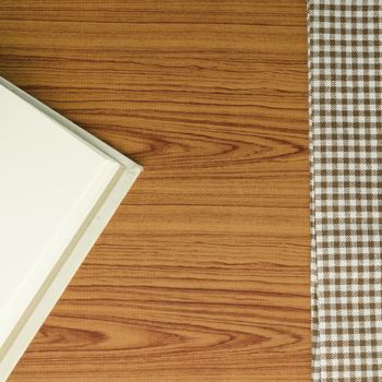 notebook with kitchen towel on wood background