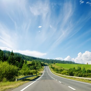 asphalt road to horizon in mountain and blue sky