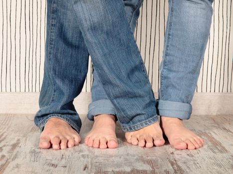 man and woman barefoot with jeans