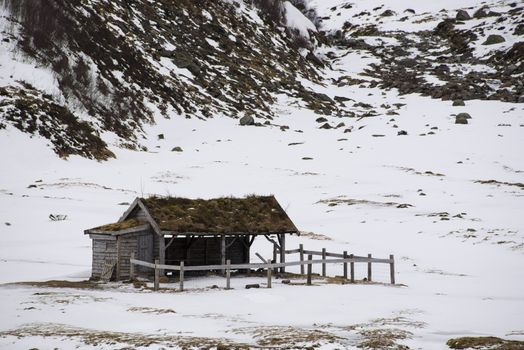 A mountain farm shed in winter