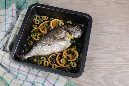 Baked Fish (Dorado) with lemon and olives