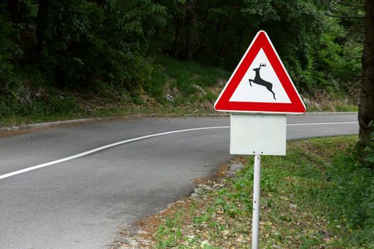 Traffic sign warns about animals by the road