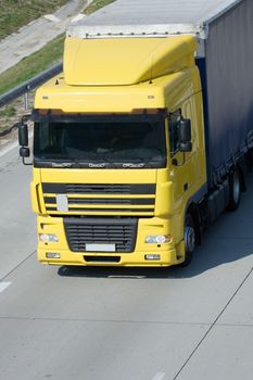 Yellow trucks roaring on the highway