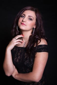 Portrait of long-haired brunette in a black dress