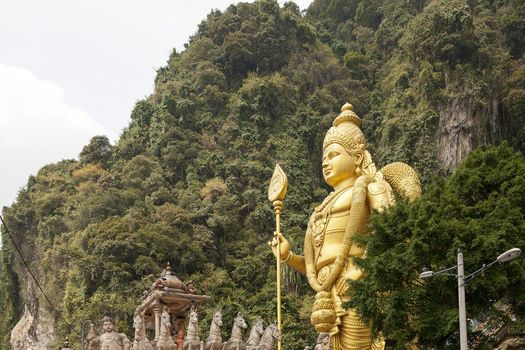 Lord Murugan Hindu Deity Statue by Hindu Temple at Batu Caves in Malaysia
