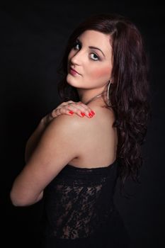 Portrait of long-haired brunette in a black dress