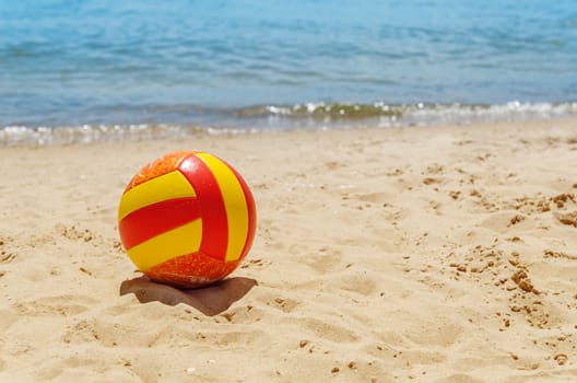 ball on sand near sea