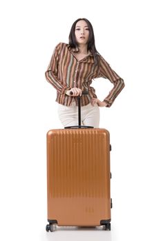 Modern Asian woman stand with a luggage, full length portrait on white background.