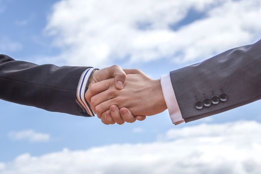 Closeup of a business handshake for closing deal