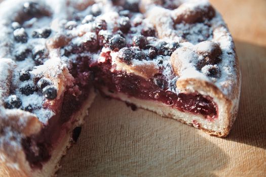 Canberry cake with blackberry on a wooden table