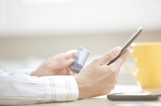 Human hand with tablet PC and credit card during lunch