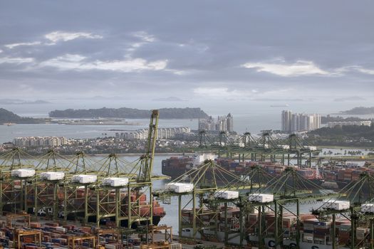 SINGAPORE, SINGAPORE - JAN 30, 2014: Port of Singapore with Container Ships Loading and Unloading Containers in the second busiest port in the world in terms of tonnage.