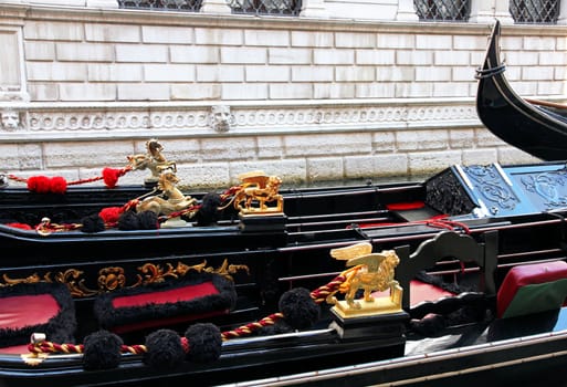 Italy. Venice. Details of typical venitian gondolas. The winged lion and golden horse on a venetian gondola.