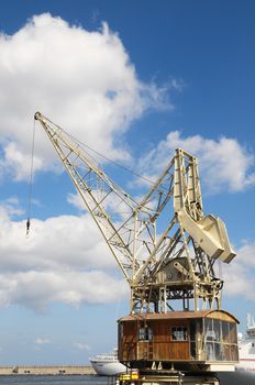 Old Vintage Wooden Port Crane on a Blue Sky