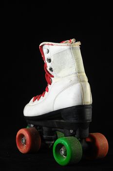 Used Vintage Consumed Roller Skate on a Black Background