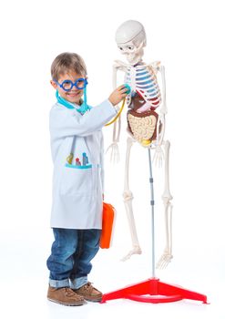 A little smiling doctor with stethoscope and skeleton. Isolated on white background