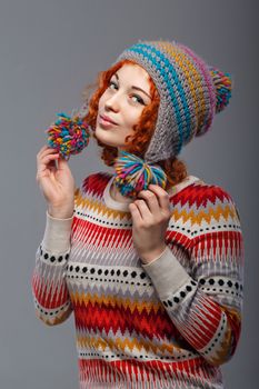 Attractive young red-haired girl in a warm knitted hat