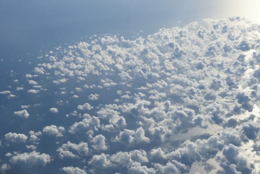 Blue and silver clouds background, view from airplane
