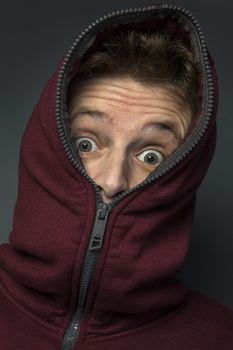 Man in hoody with a look of surprise on his face.