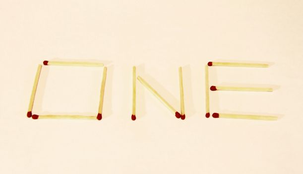 Word One signing by matches isolated on the white background