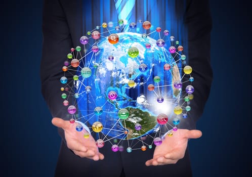 Man in suit holding a earth in hand. Application icons around earth. The concept of software