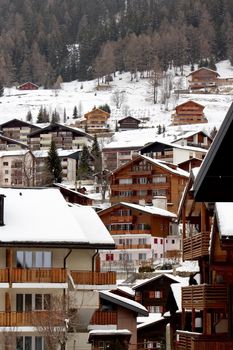 Close up on wooden balconies of a chalet at Loeche les bains in winter, Switzerland