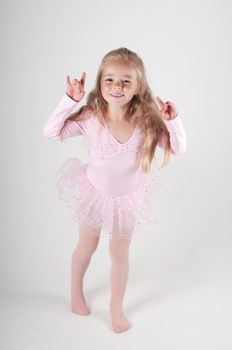 Studio shot of emotional ballet dancer girl in pink