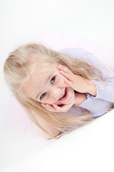 Studio portrait of happy blond little girl