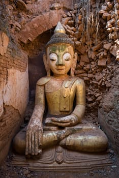 Buddha image in ancient Burmese Buddhist pagodas Nyaung Ohak in the village of Indein on Inlay Lake in Shan State, Myanmar (Burma).