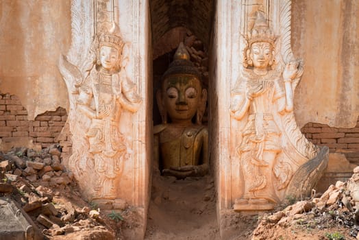 Buddha image inside of ancient Burmese Buddhist pagodas Nyaung Ohak in the village of Indein on Inlay Lake in Shan State, Myanmar (Burma).