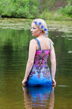 Shot of female in a dress in the water