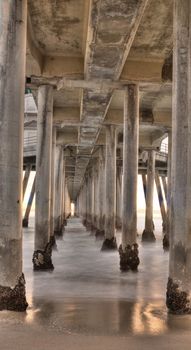 Long exposure captures slow moving waves under The Huntington Beah Pier in Huntington Beach, California