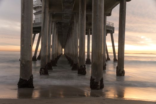 Long exposure captures slow moving waves under The Huntington Beah Pier in Huntington Beach, California