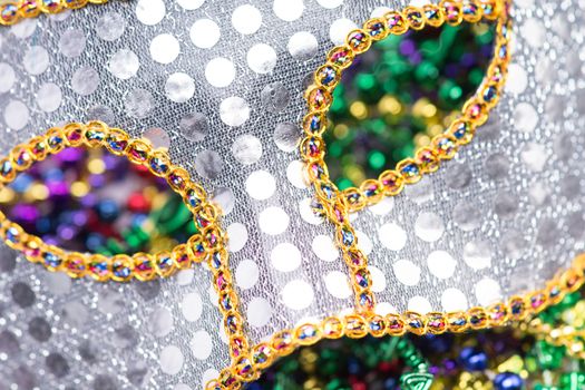 Colorful Mardi Gras Mask with beaded background