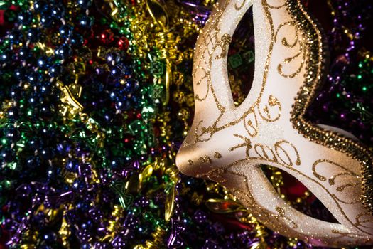 Colorful Mardi Gras Mask with beaded background