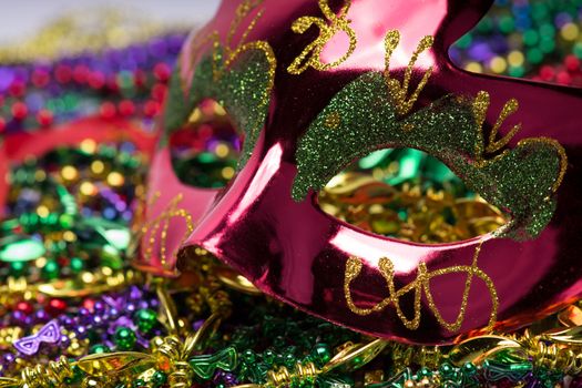 Colorful Mardi Gras Mask with beaded background