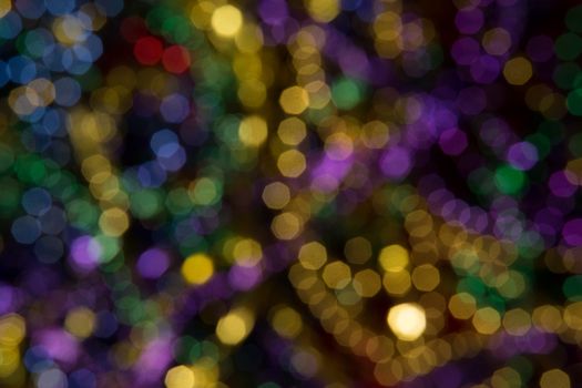 Abstract background of out of focus Mardi Gras Beads