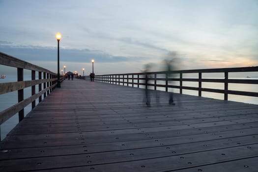 People walking with motion blur at The Seal Beach Pier in Seal Beach, California