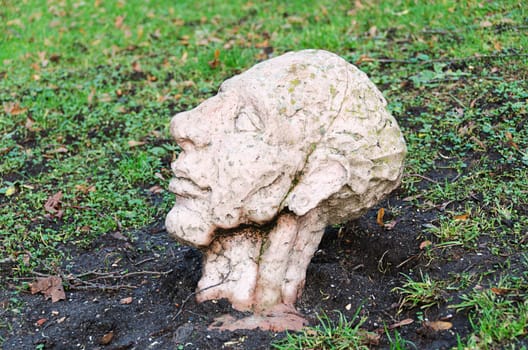 a buried man in the lawn only the head is visible