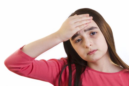 Little girl with headache looking upset at camera