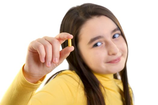 young girl holding capsule and looking to camera