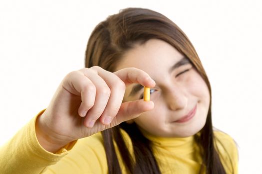 young girl holding and analizing capsule