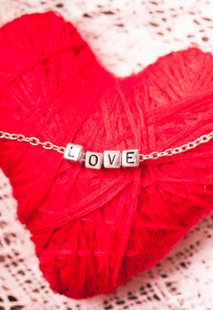 love letters on the chain close up on red background