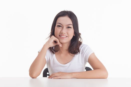 Asian woman isolated on white background. white t-shirt, sit on chair with table