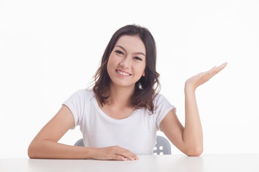 Asian woman isolated on white background. white t-shirt, sit on chair with table