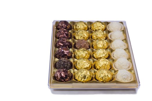 A variety of chocolates in a box. Presented on a white background.