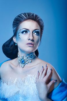 Attractive girl with scenic makeup in the image snow queen