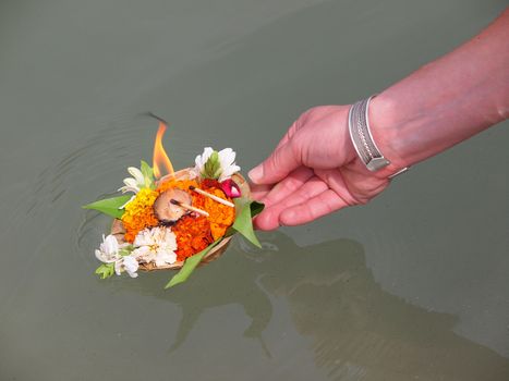 arangement of flowers and candle on the ganges river       
