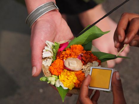 flower arangement and candle on the ganga river      