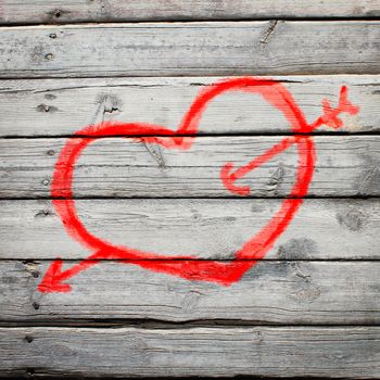 Red heart painted on a wooden surface. The concept of Valentine's Day